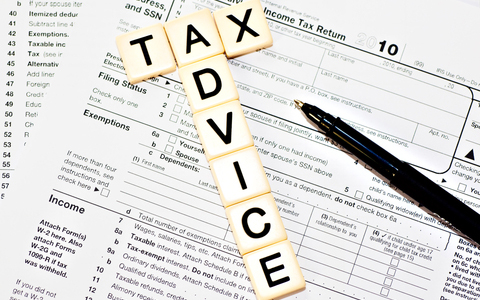 Tax Advice spelled in tiles over a tax document